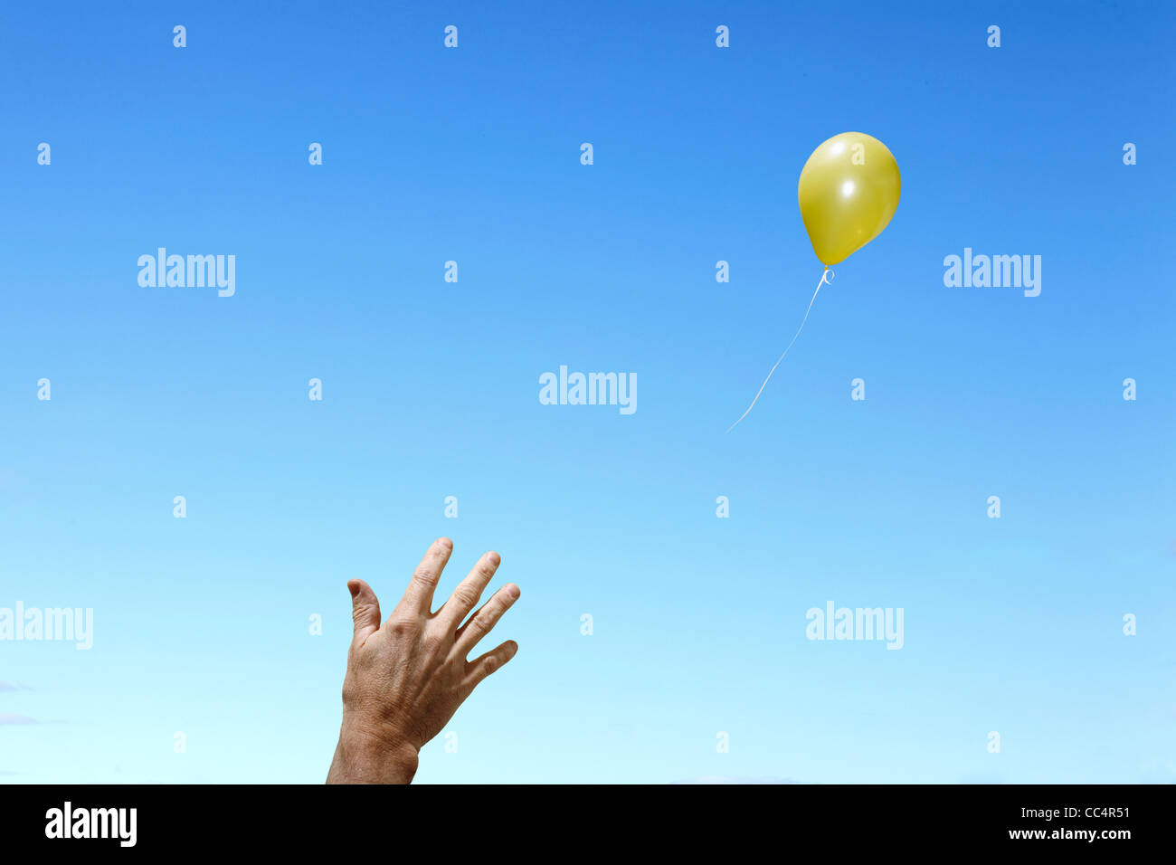 Hand releasing Balloon Stock Photo