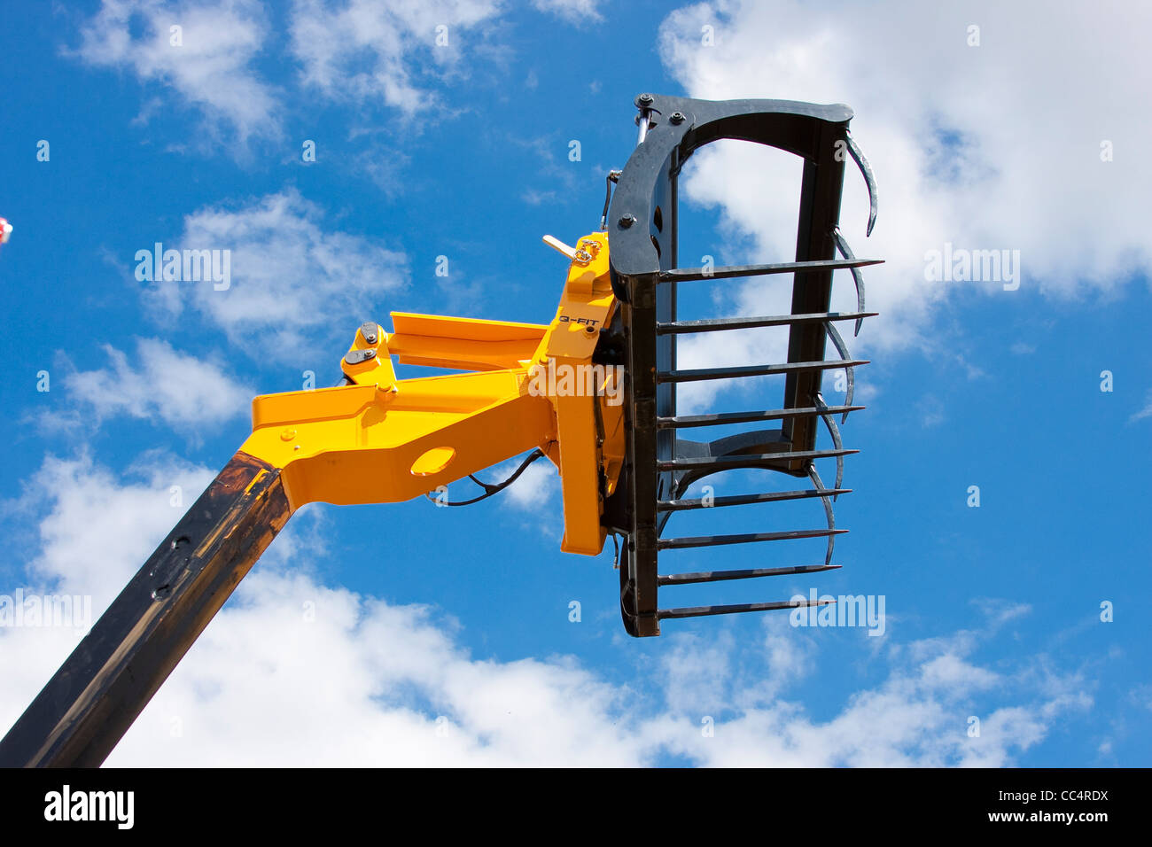Yellow and Black Agricultural Spike Grab against Vivid Blue Sky Stock Photo