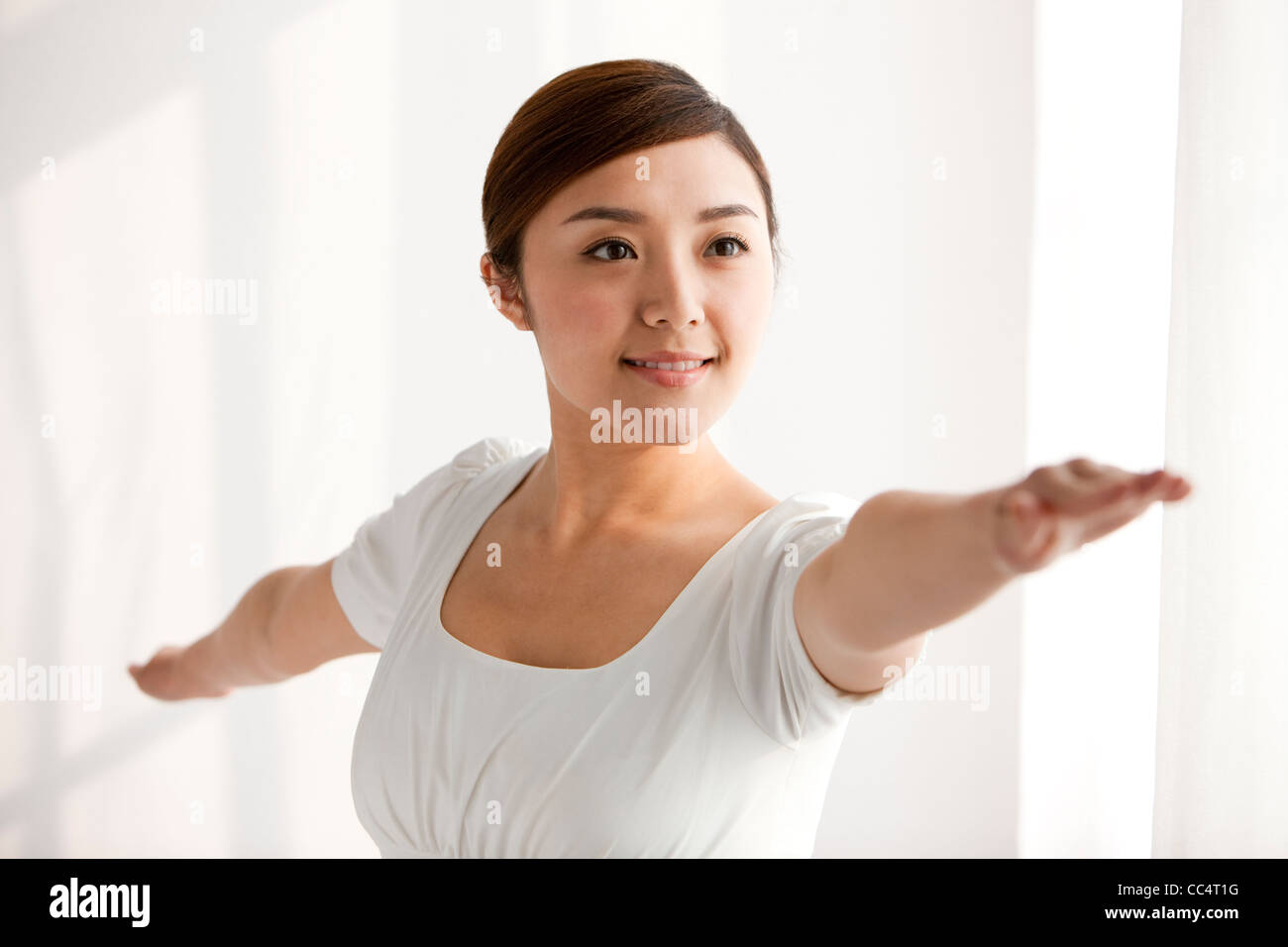Woman practicing yoga arms outstretched hi-res stock photography and ...
