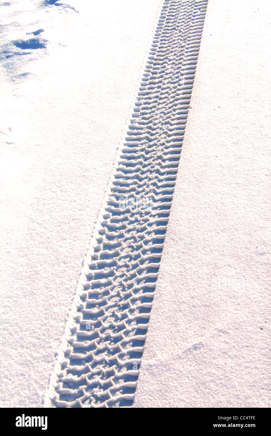 40,511.00235 Winter snow showing a truck's snow tire tracks gripping and providing strong sturdy traction in fresh snow. Stock Photo