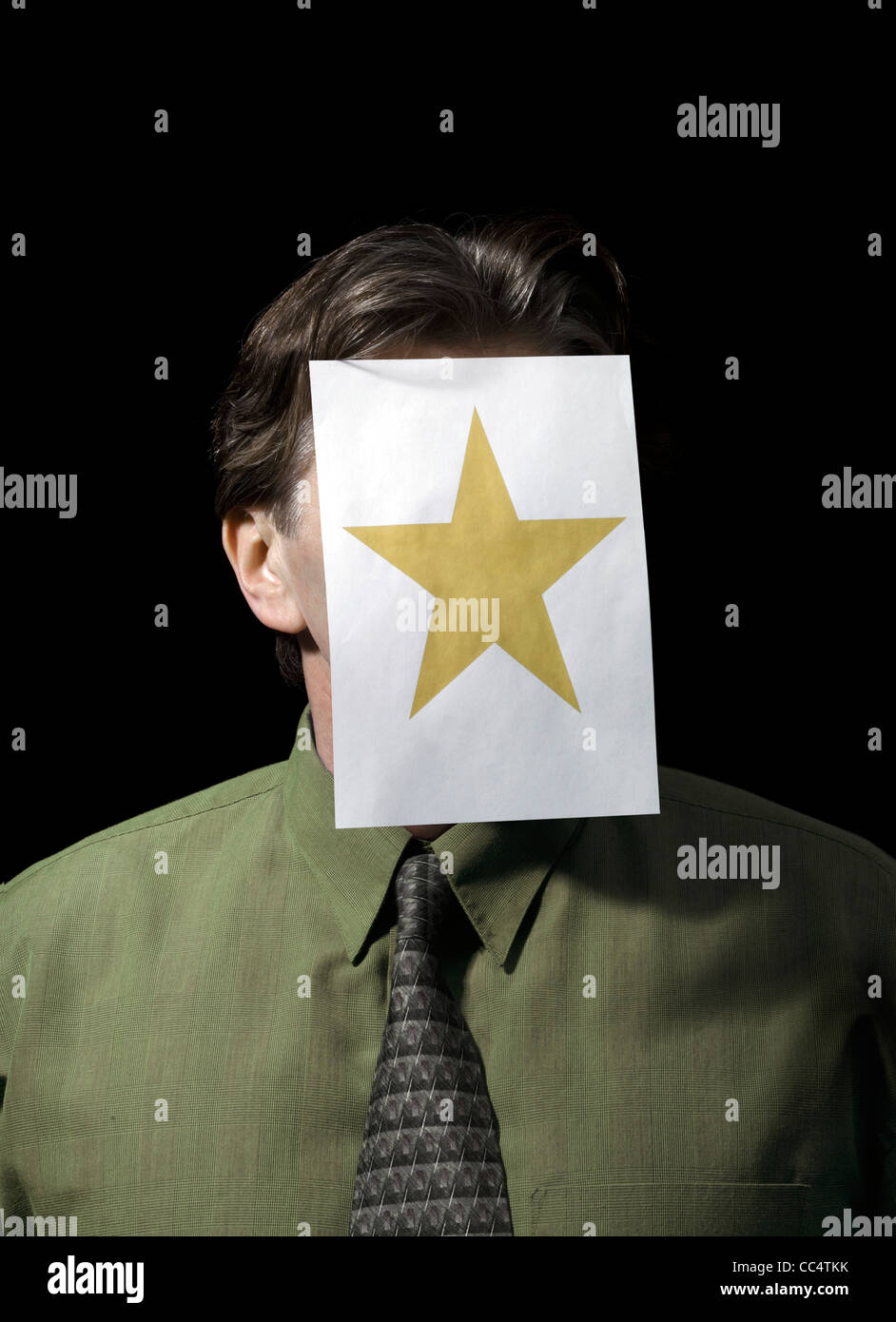 Studio shot of a Portrait of a Businessman with Paper star on Face Stock Photo