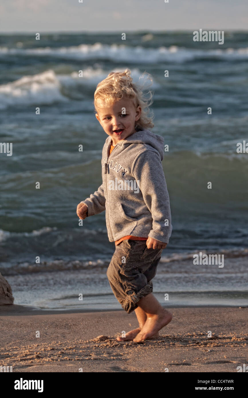 Toddler running on the beach Stock Photo