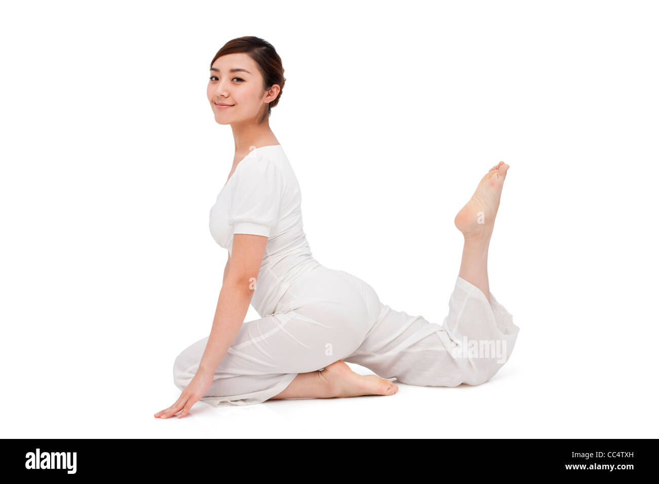 Young woman stretching on the floor Stock Photo - Alamy