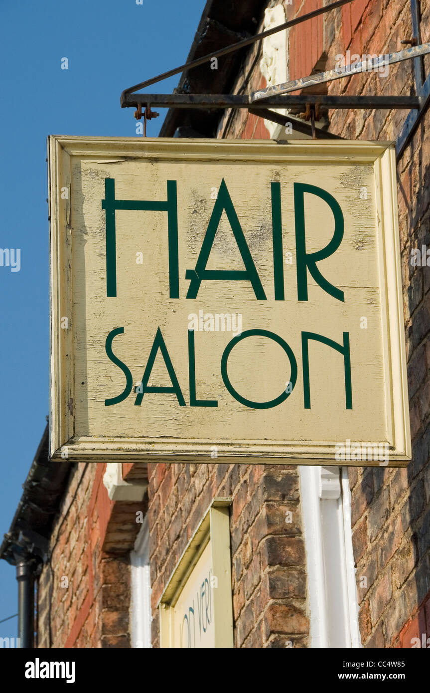 Close up of generic barber barbers hairdressers hair salon shop sign exterior England UK United Kingdom GB Great Britain Stock Photo