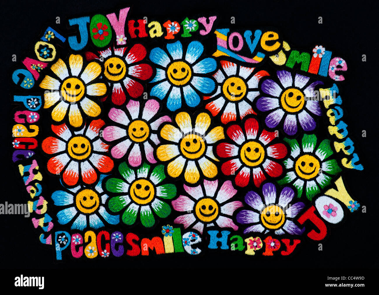 Embroidery iron on patches of Multicoloured Love, Peace, Happy, Smile, Joy, Groovy words with flowers on a black background Stock Photo