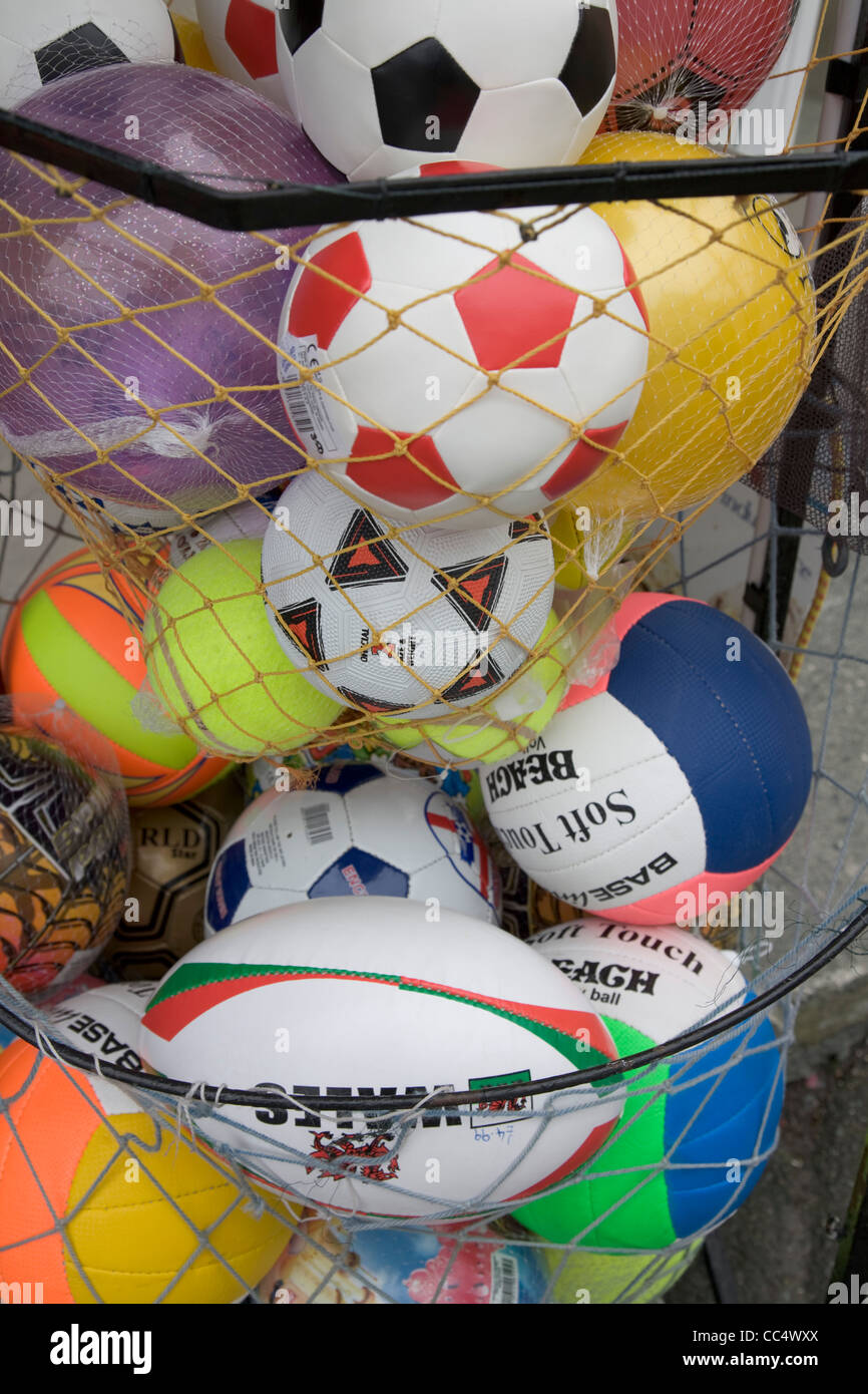 A basket filled with Soccer and Rugby beach balls Stock Photo - Alamy