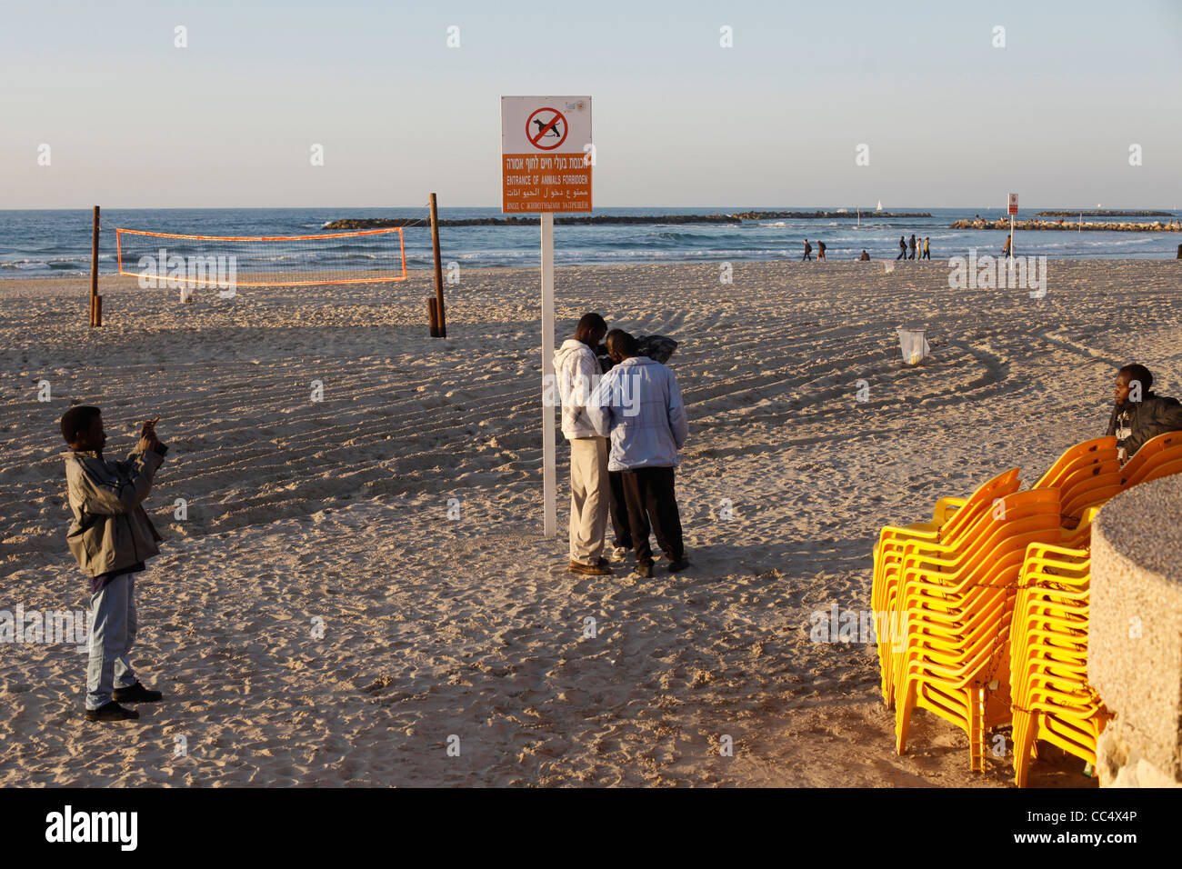 Migrant workers in the beach at the Mediterranean seashore of Tel Aviv in Israel Stock Photo