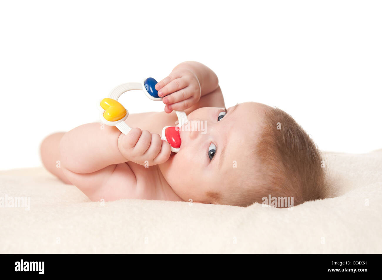 cute six months old baby boy playing with a rattle, isolated on white background Stock Photo