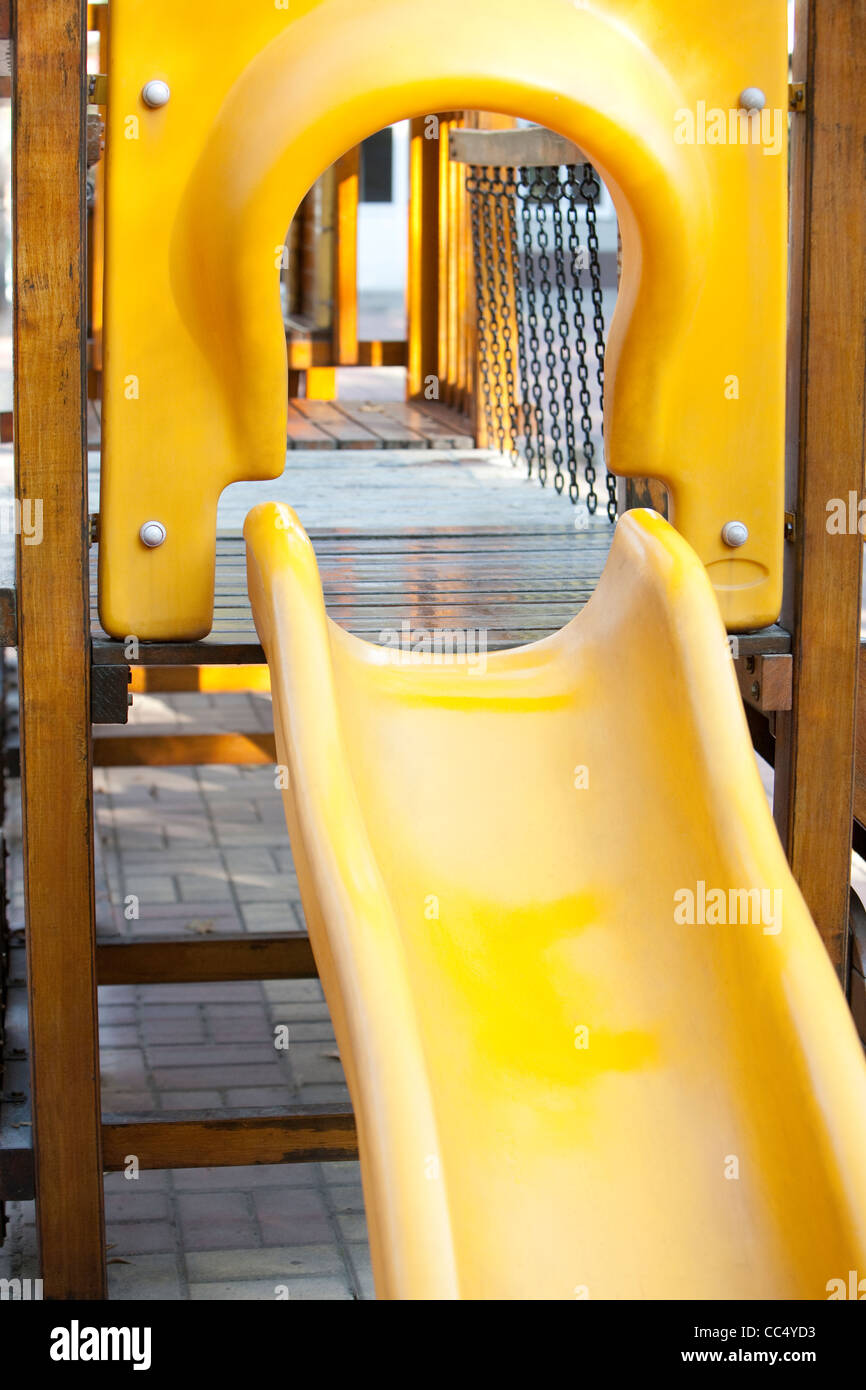 Yellow slide in playground Stock Photo Alamy