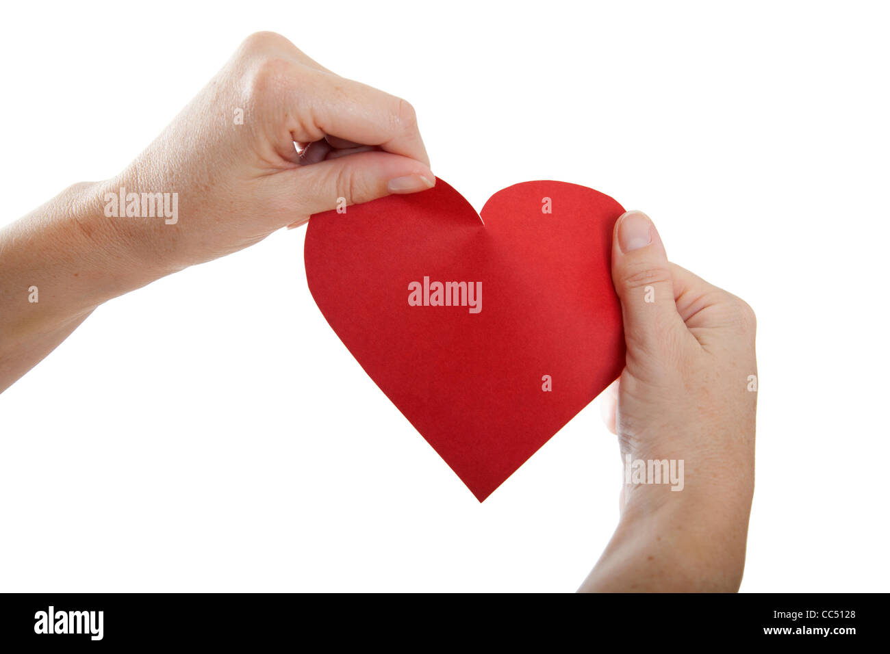 Hands about to tear paper heart Stock Photo