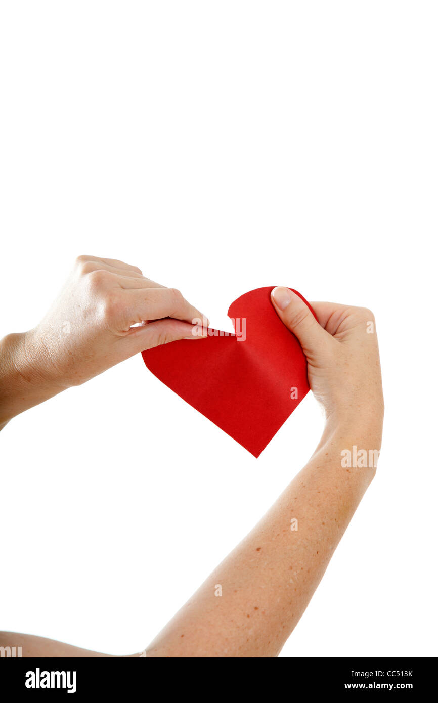 Hands Ripping paper heart Stock Photo