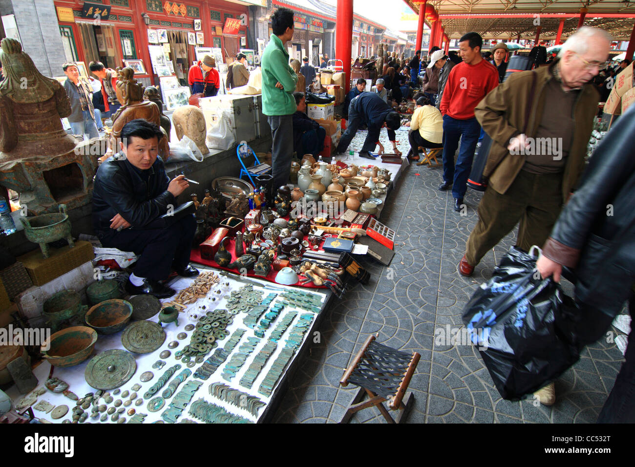 Street stall vendor selling antique, Panjiayuan Antique Market, Beijing