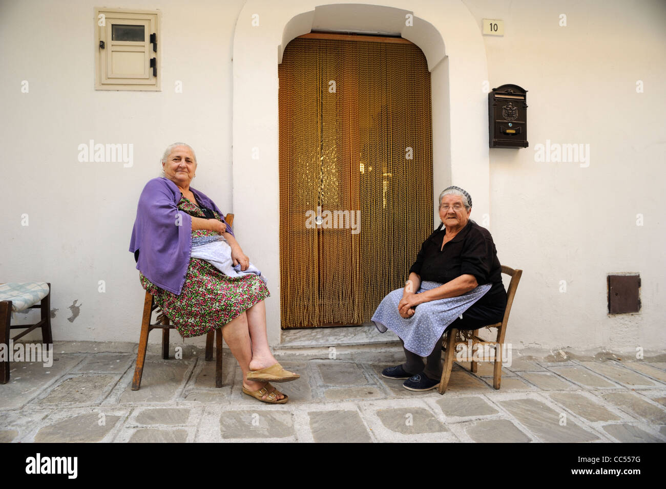 italy, basilicata, roccanova, old italian women outside house Stock Photo