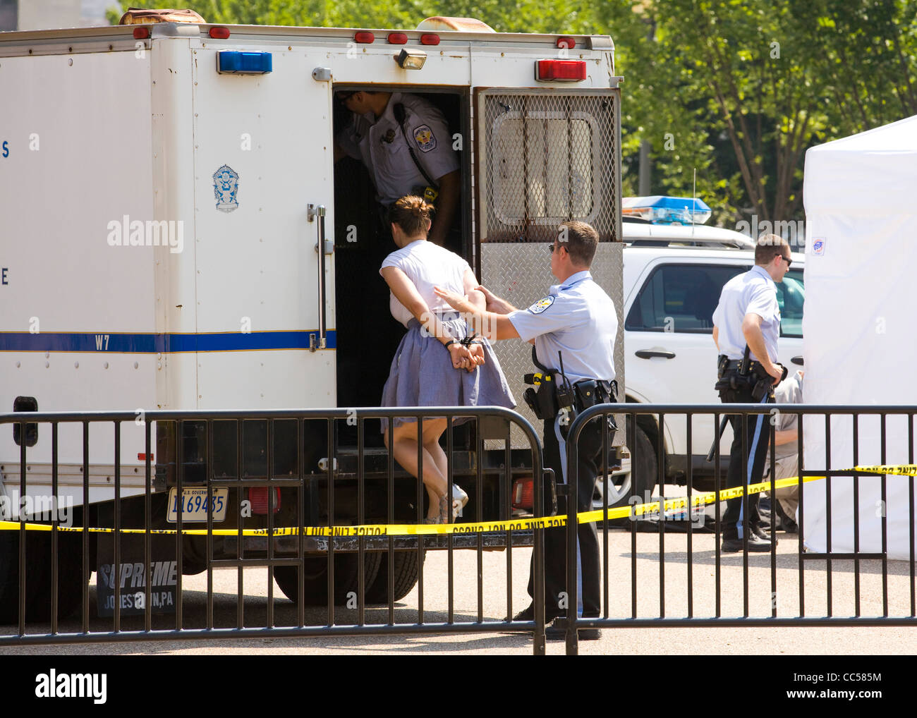A police detained woman is led into a paddywagon - Washington, DC USA Stock Photo