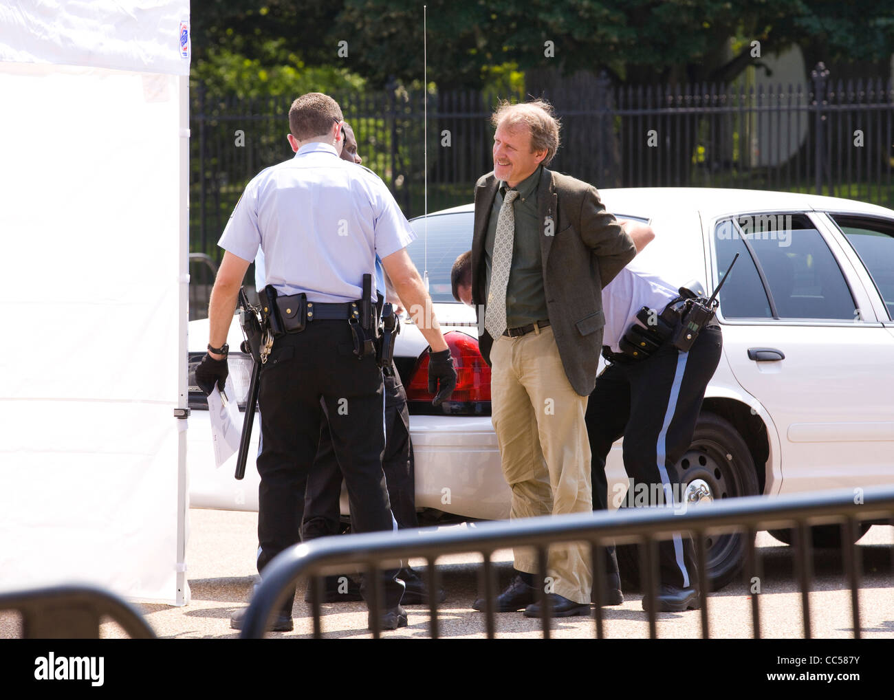 A white male handcuffed and patted down by police - Washington, DC USA Stock Photo