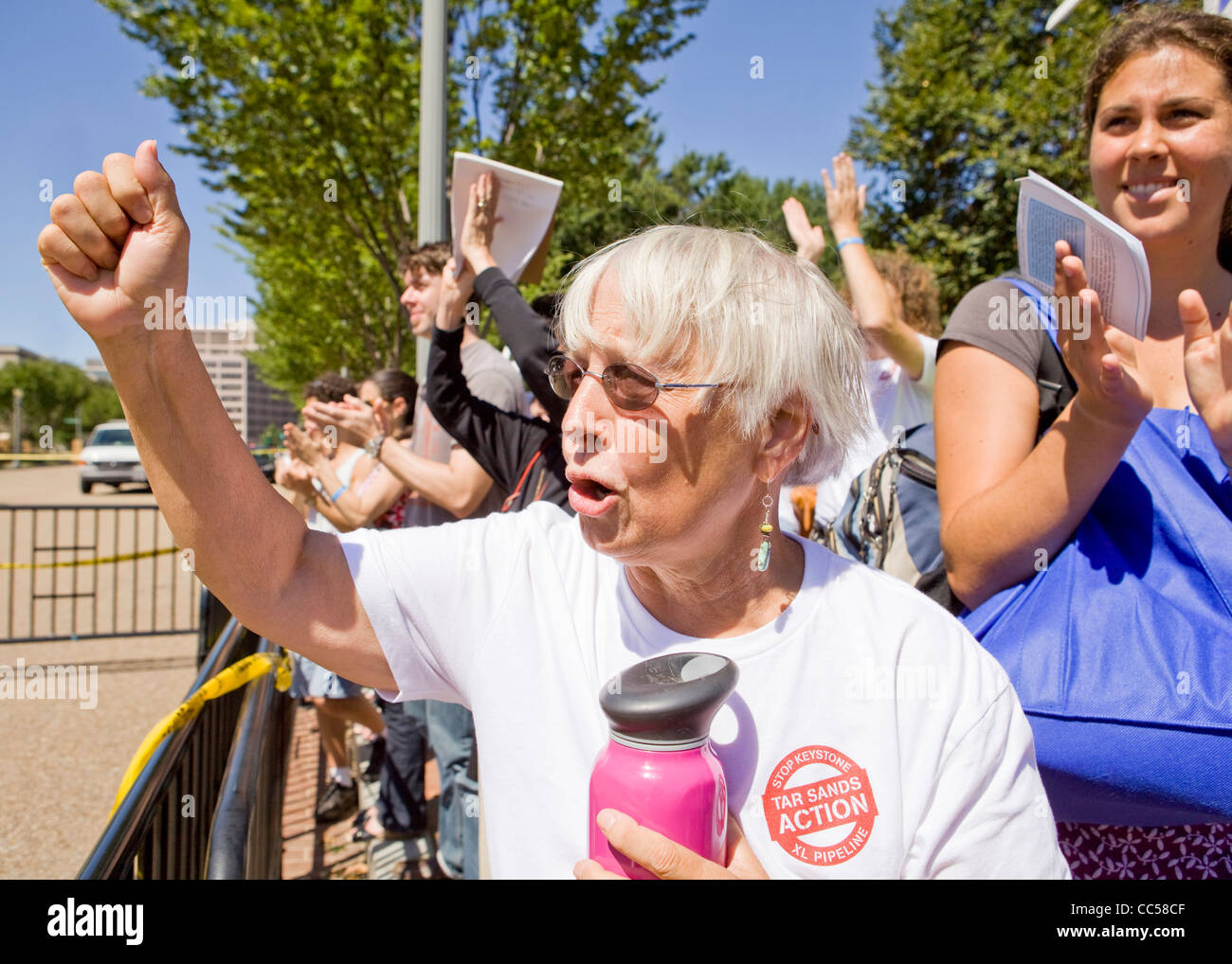 An elderly woman raises her fist during a demonstration Stock Photo