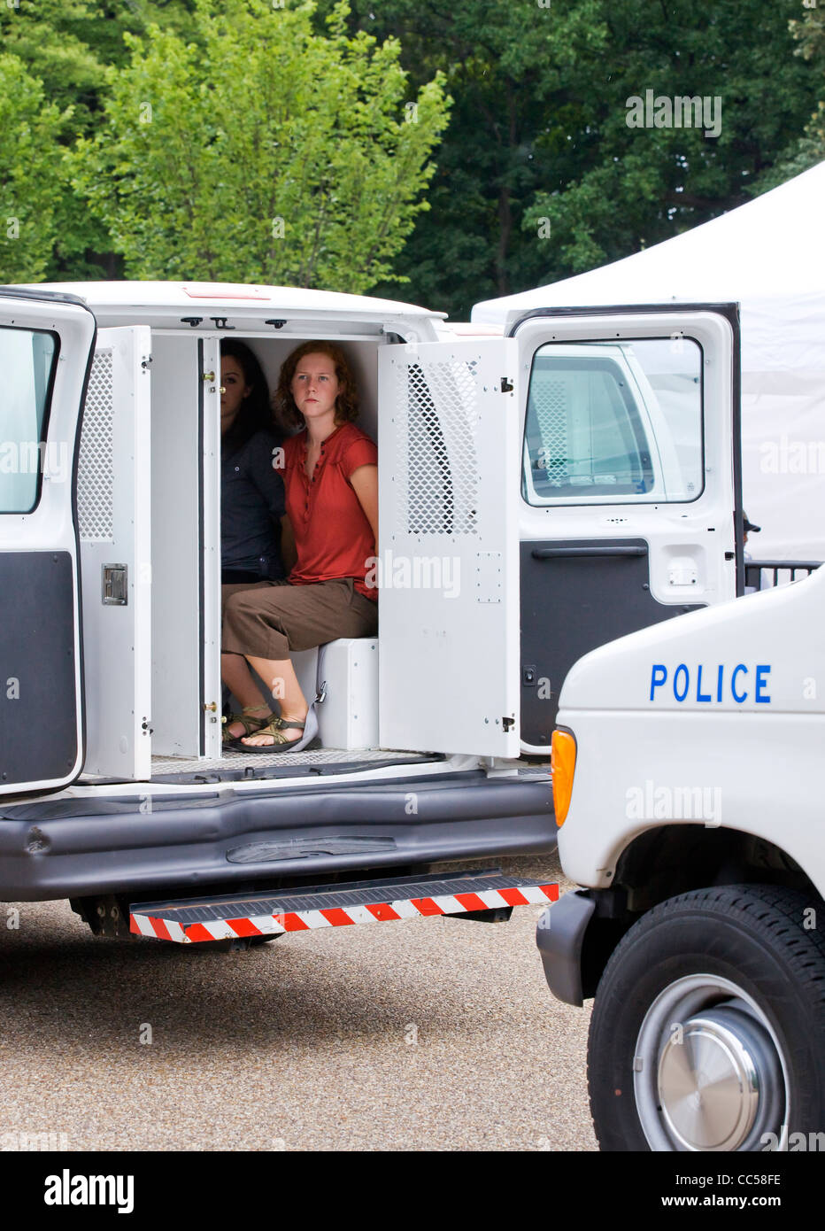 A police detained woman sits in a paddywagon - Washington, DC USA Stock Photo