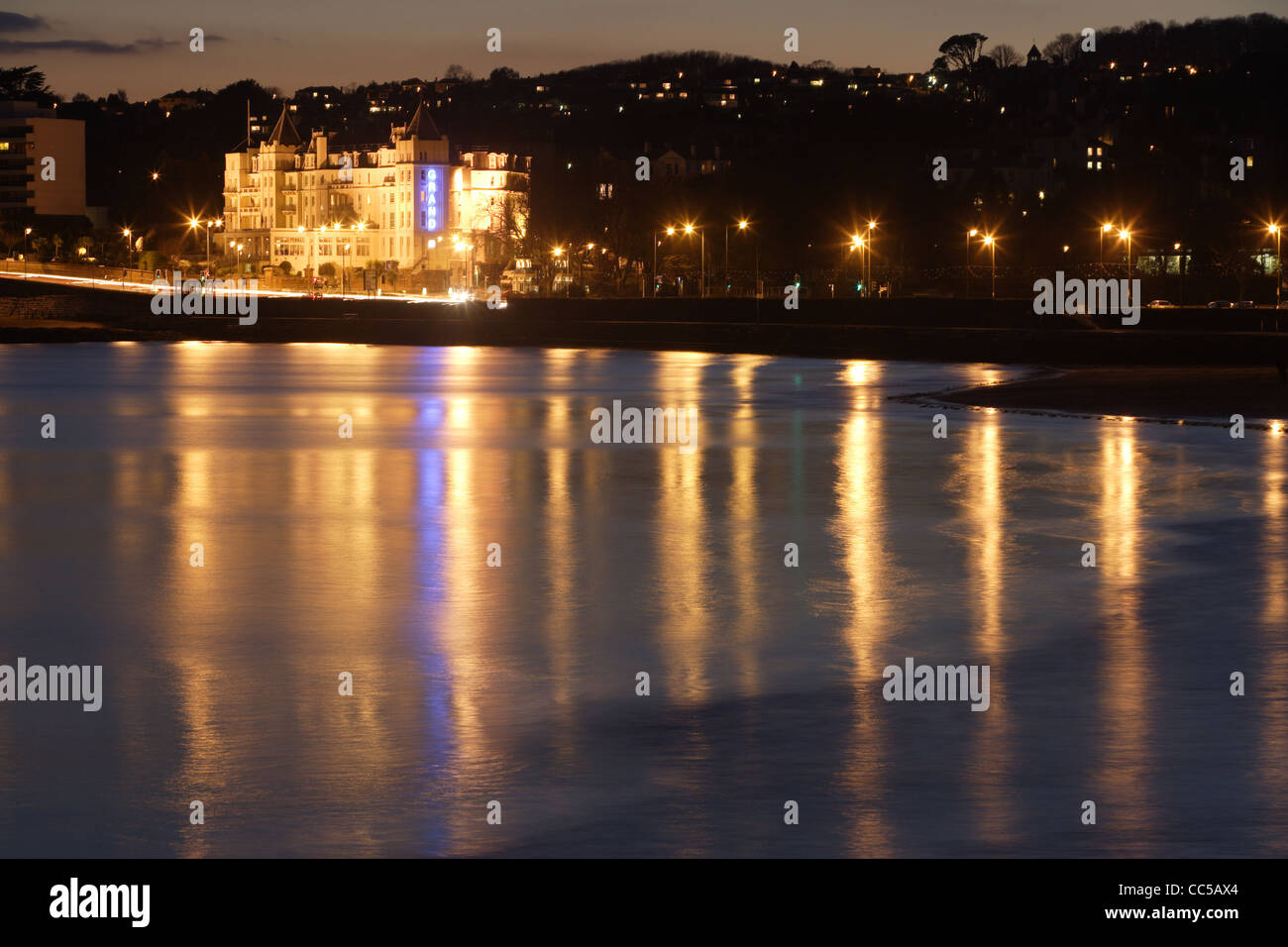 Evening scens of the Grand hotel in Torquay, Devon Reflecting in the calm water Stock Photo