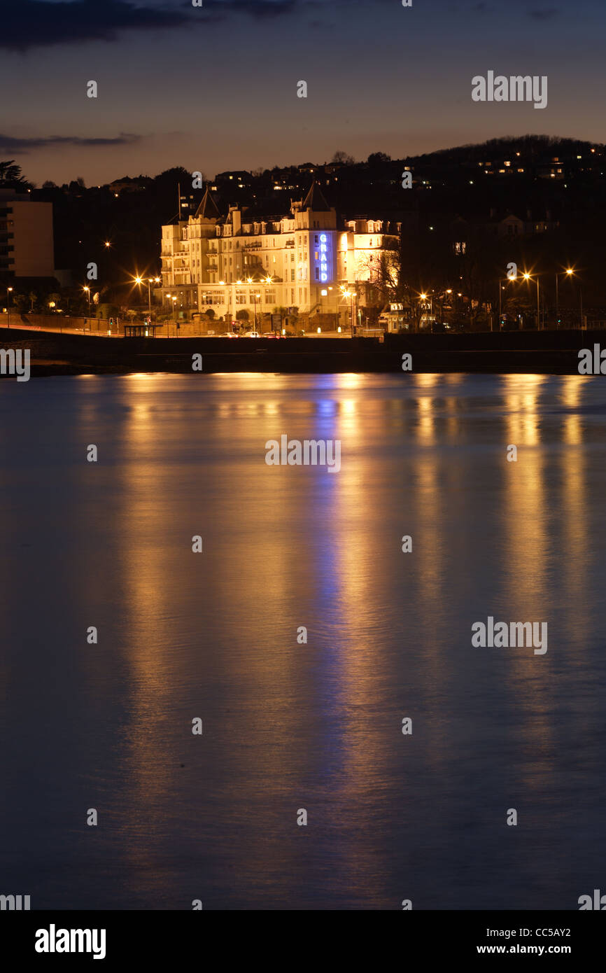 Evening scens of the Grand hotel in Torquay, Devon Reflecting in the calm water Stock Photo