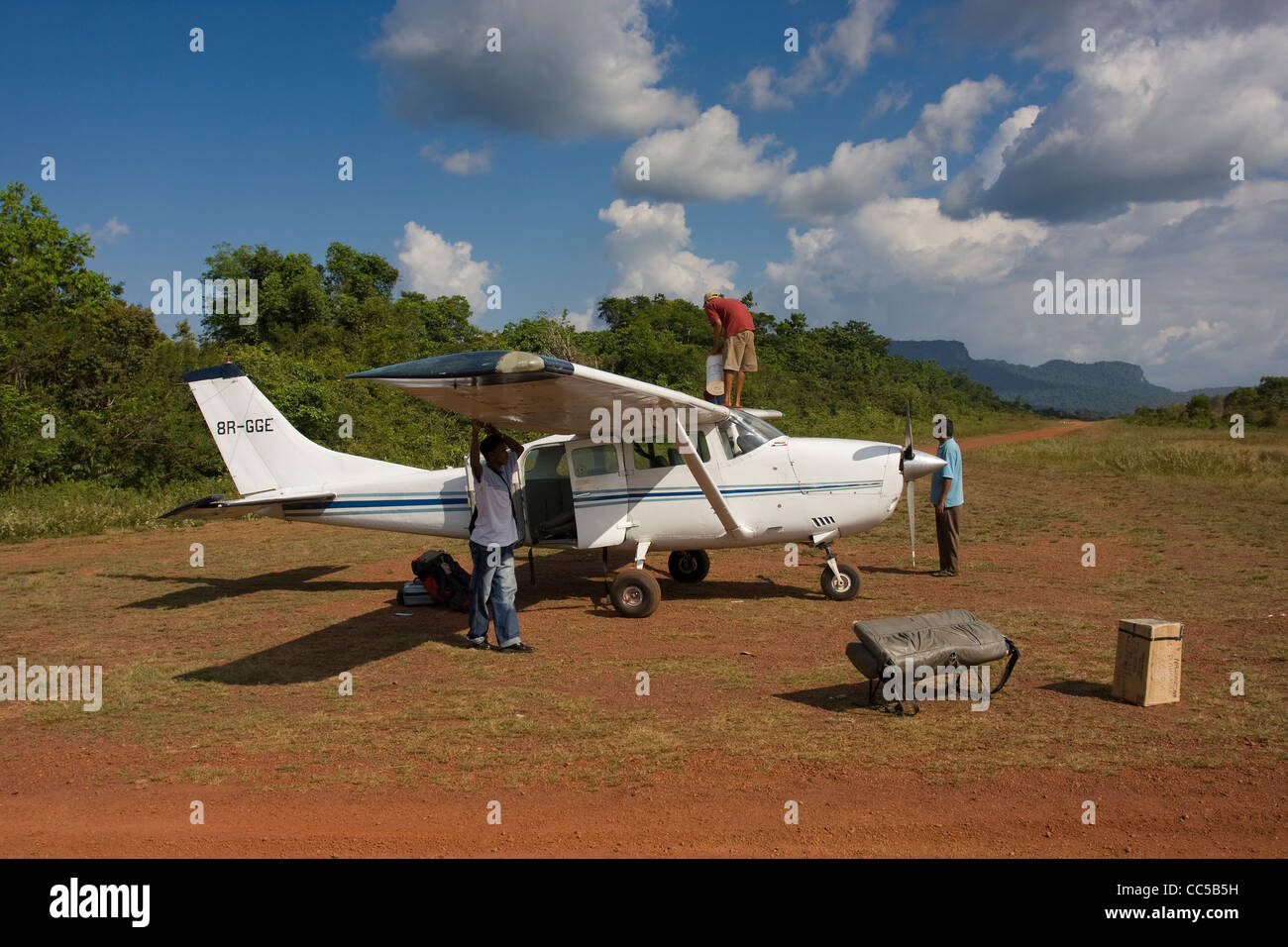 Light aircraft at fueling stop prior to taking tourists back to Georgetown from Kaieteur tour, Guyana. Stock Photo