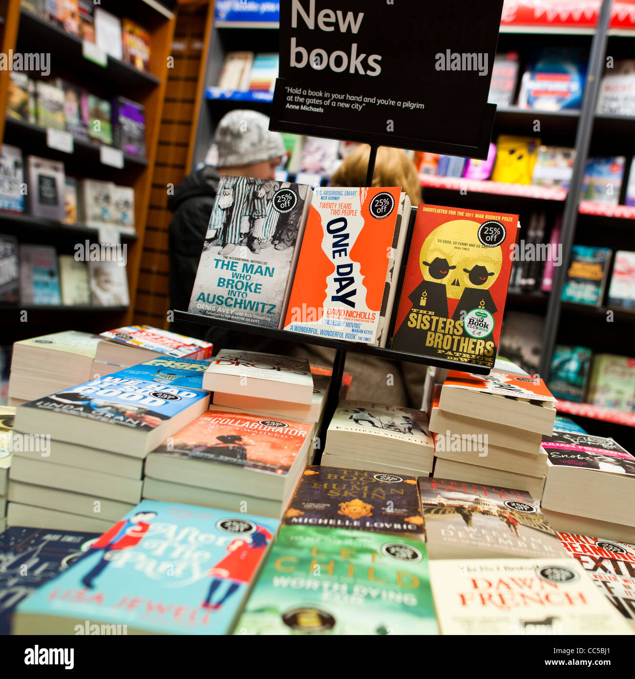 piles of new paperback books on sale inside a branch of Waterstones