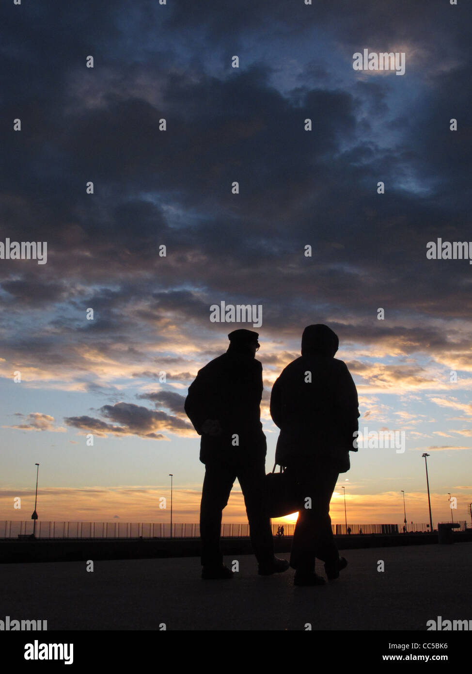 old senior elderly couple silhouette by sea at sunset Stock Photo - Alamy