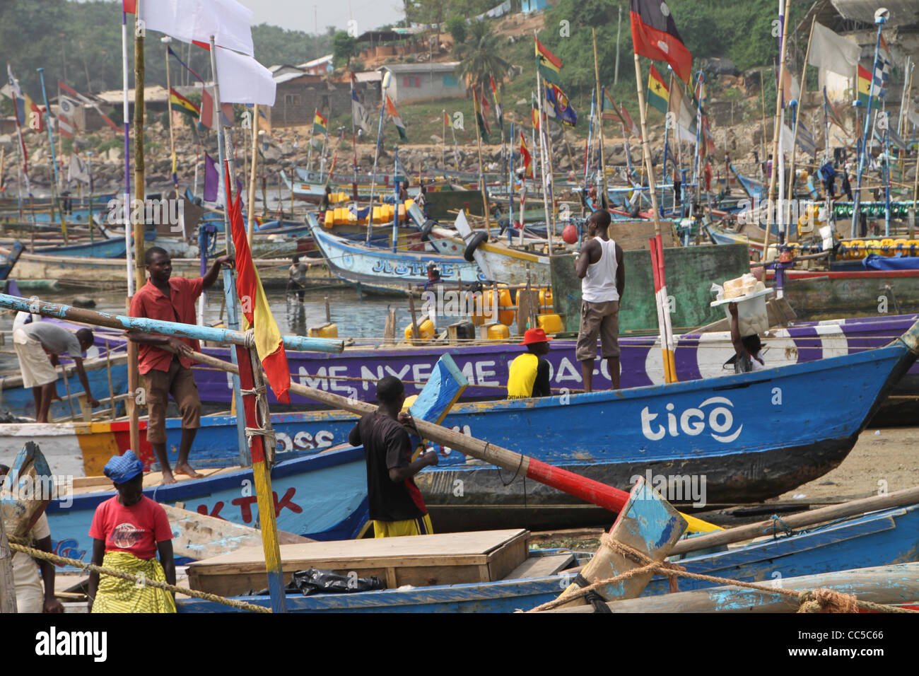 Fishermen preparing fishing boats in harbour on Cape Coast, Ghana Stock Photo
