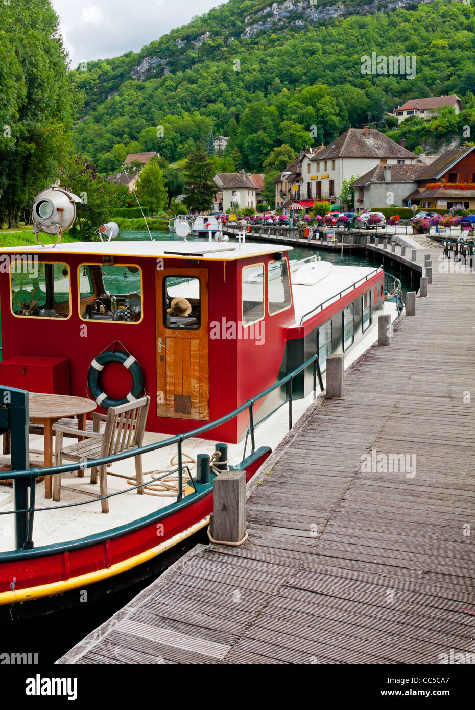 Boat moored on the Canal de Savieres in Chanaz in the Savoie area of the French Alps near to Lac du Bourget south eastern France Stock Photo