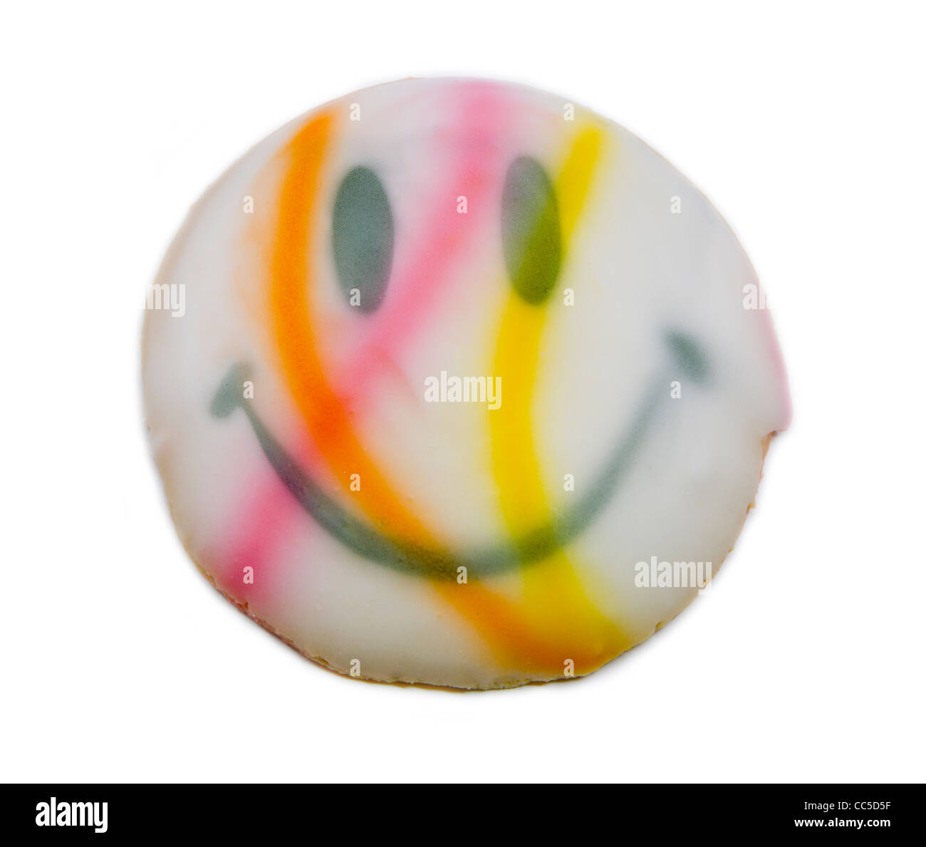 A colorful orange, white, yellow, pink and white smiley face cookie fresh from the bakery. Stock Photo