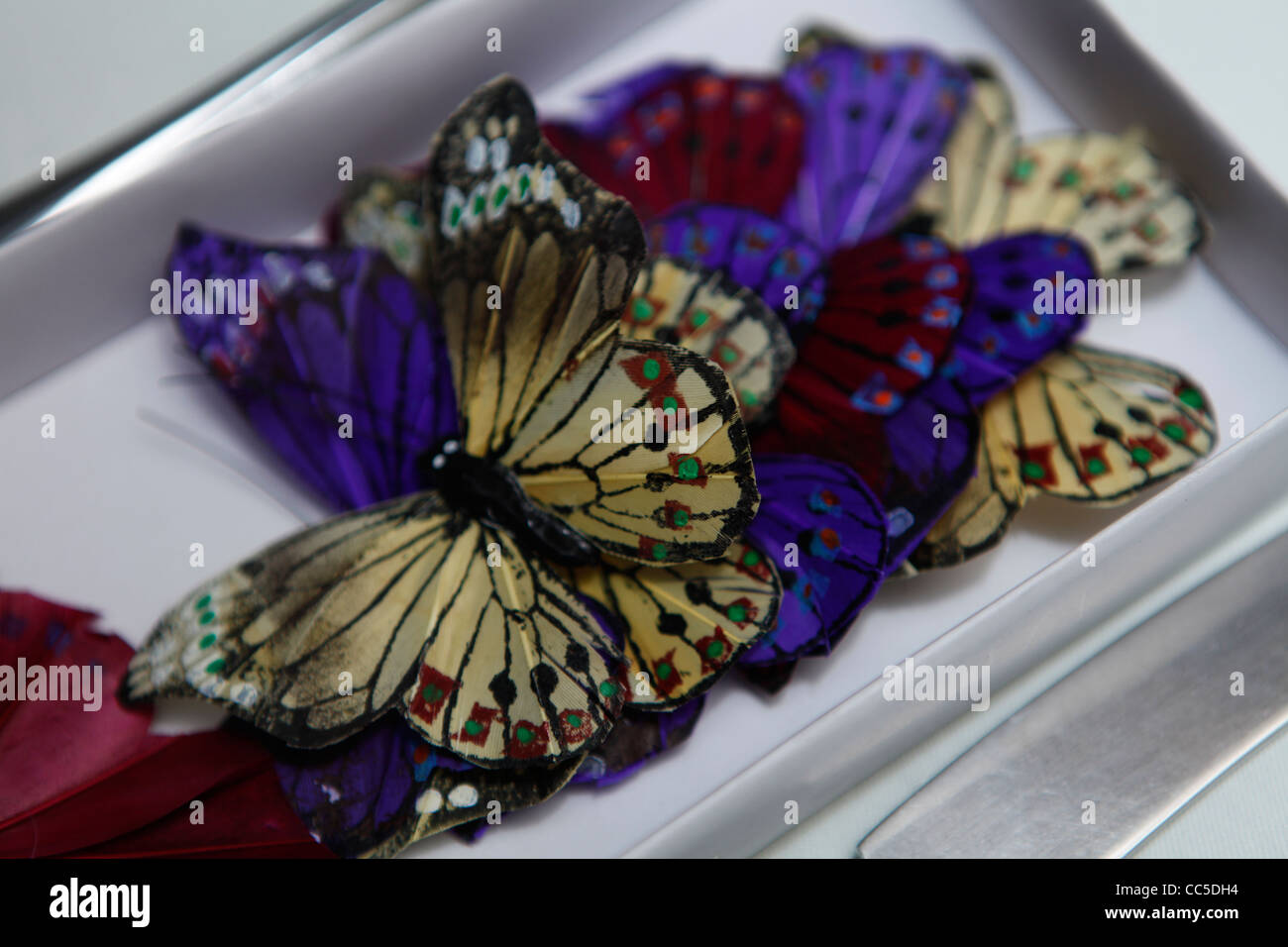 Fake colourful butterflies handed out as wedding favours at a wedding