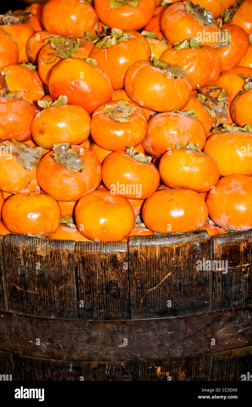 Fuyu Persimmons in Wooden Barrel Stock Photo