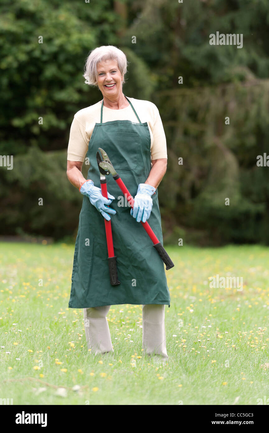 Active senior woman in the garden Stock Photo - Alamy