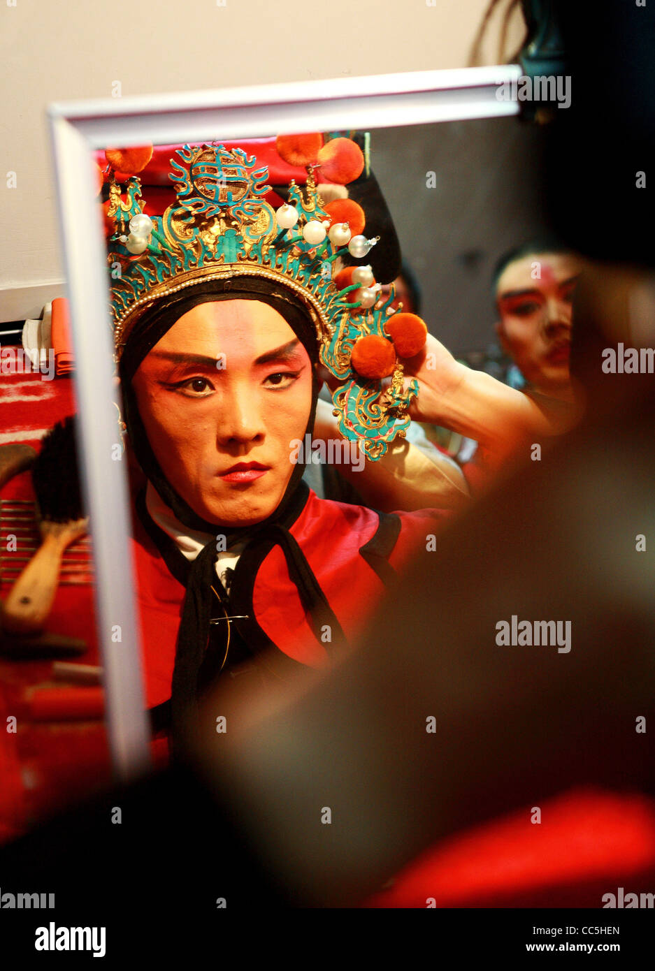 Peking opera performer wearing decorated hat, Beijing, China Stock Photo