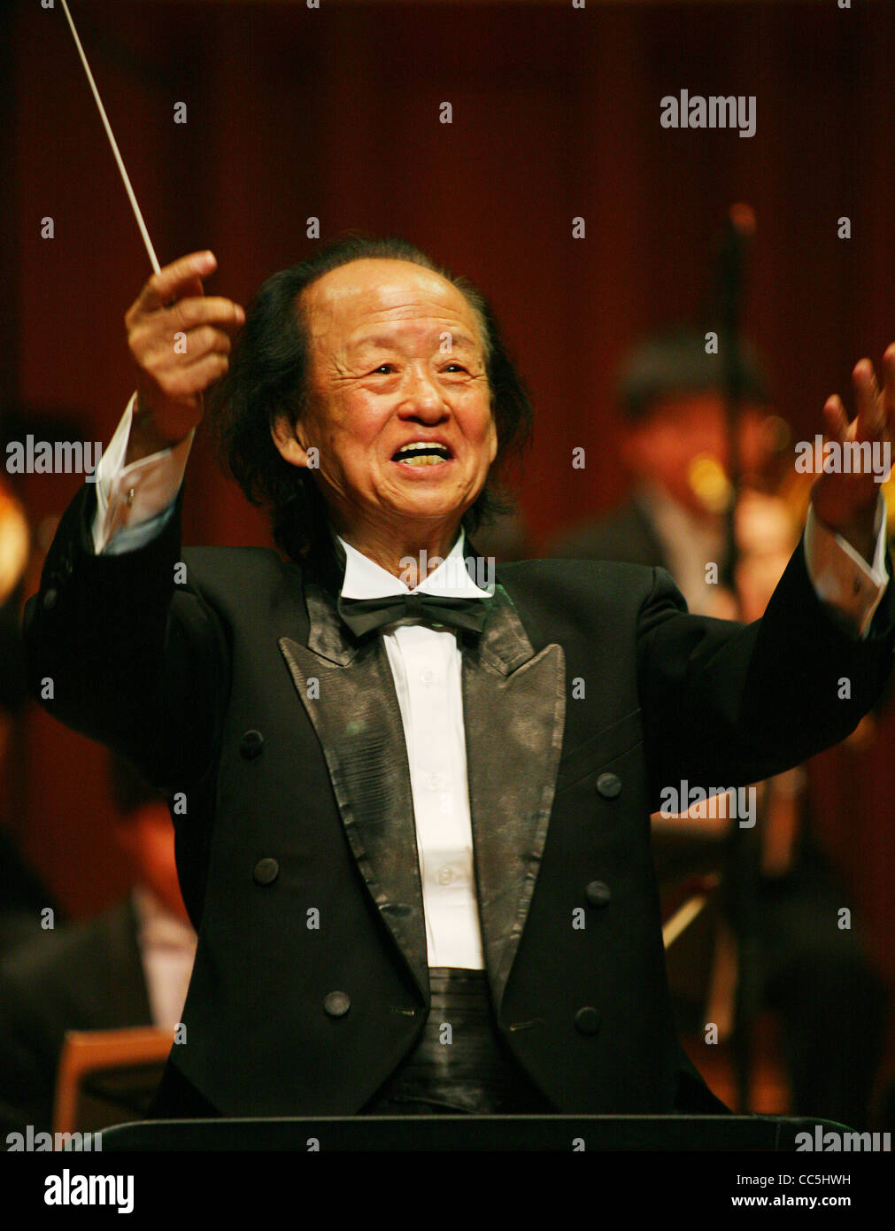 Classical music conductor raising his arms, Beijing, China Stock Photo