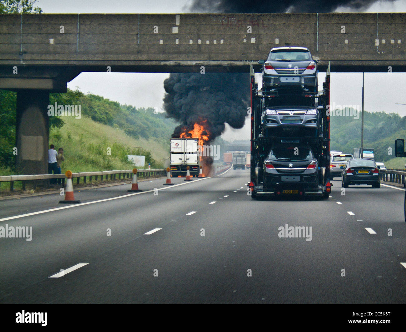Lorry on fire, on the hand shoulder of the M1 motorway. UK Stock Photo