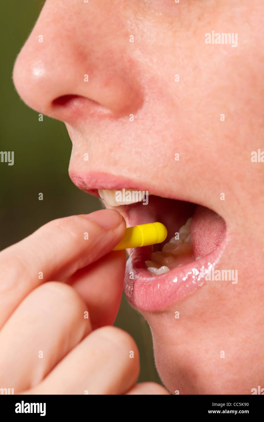 Woman taking tablet. Stock Photo