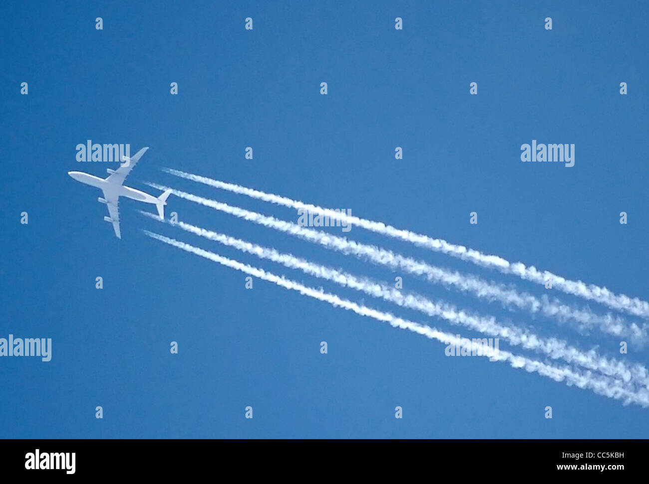 The contrails of a four engined jet, over London, England. Stock Photo