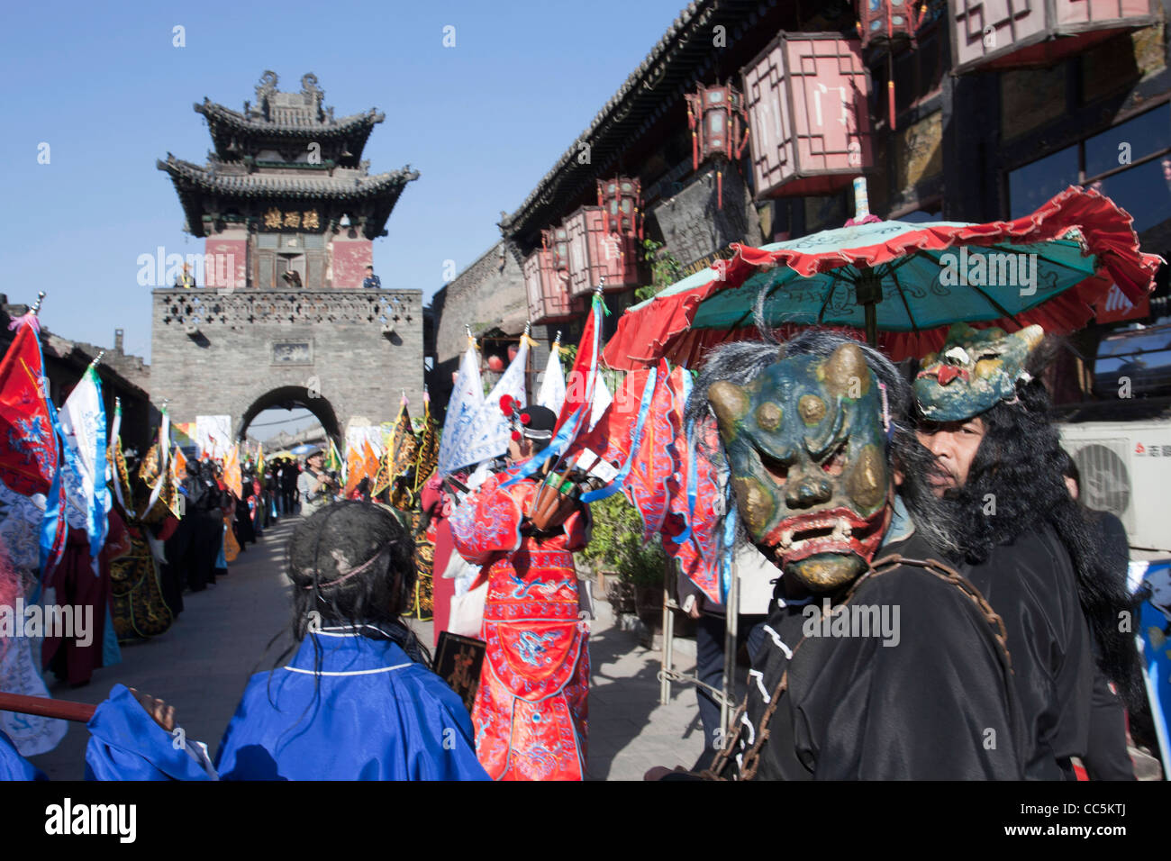 Performer wearing mask, Ancient Ming-Qing Street, Pingyao Ancient Town, Jinzhong, Shangxi , China Stock Photo