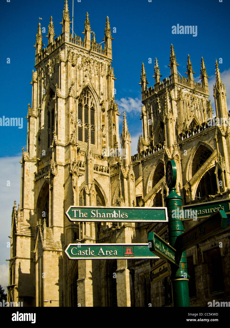 Street signpost to York’s tourist attractions with the 2 west towers of York Minster in the background. Stock Photo