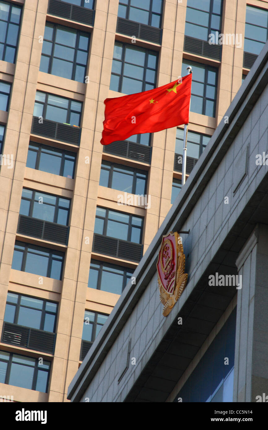 Chinese National Flag flying above the Changchun Administration For Industry & Commerce Building, Changchun, Jilin, China Stock Photo