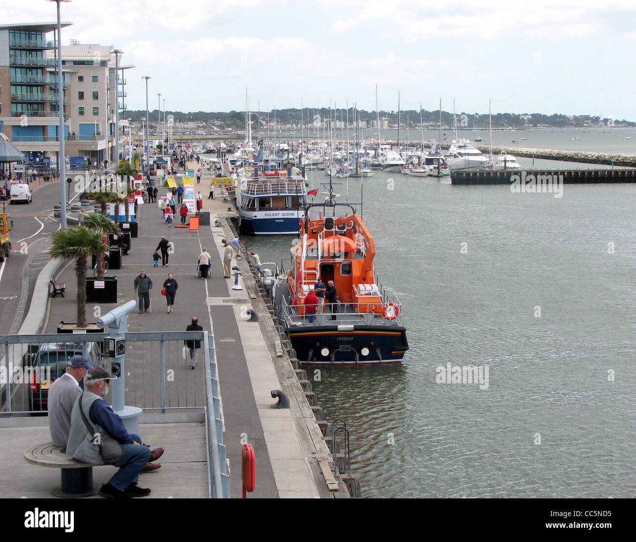 The Quay at Poole, Dorset, England. The orange boat is a Severn class lifeboat (registration 17-31) on trials after refurbishmen Stock Photo