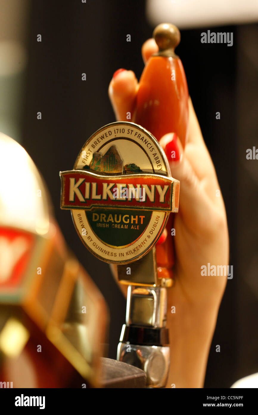 A beer tap displays the Irish Kilkenny beer logo Stock Photo Alamy