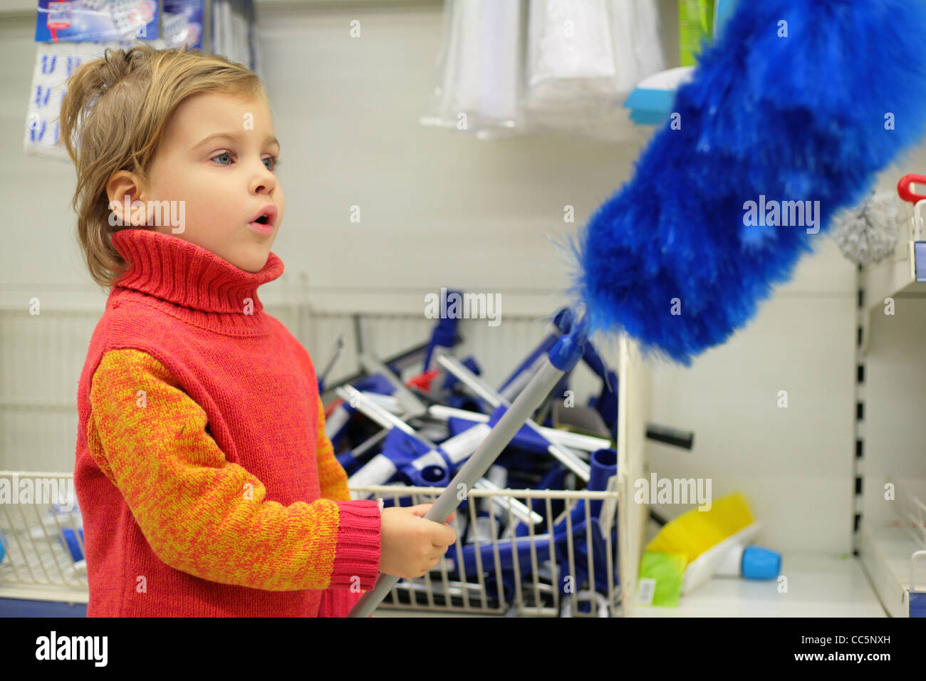 The small customer is delight by a blue brush for a dust Stock Photo