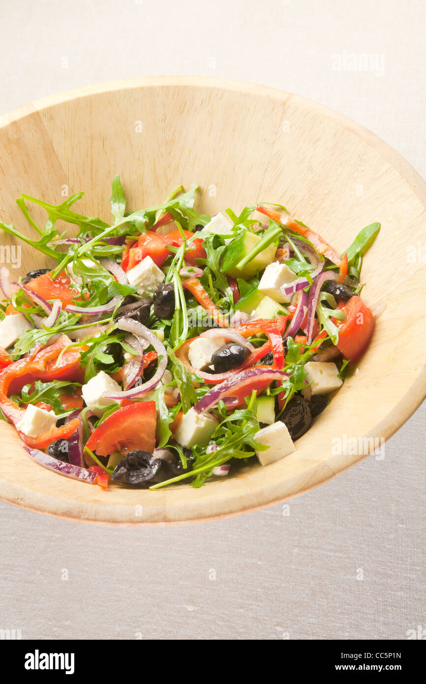 Greek salad in wooden bowl Stock Photo