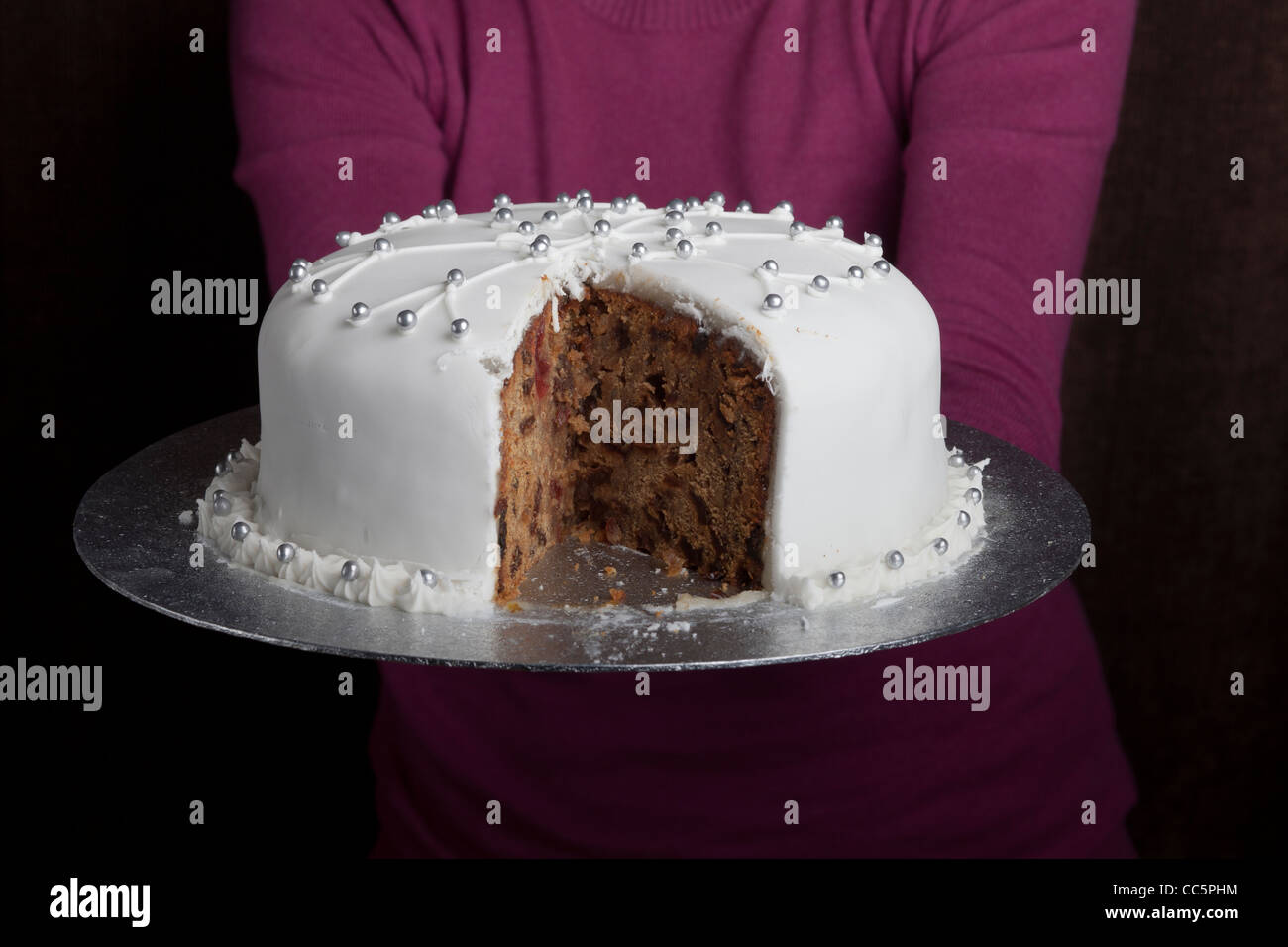 Close-up of a lady holding a Christmas cake Stock Photo