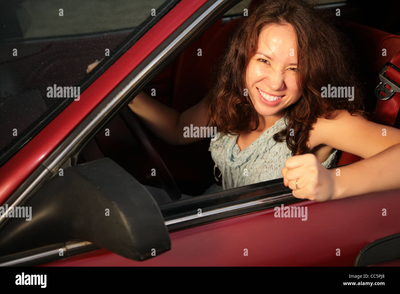 Woman in the red car Stock Photo Alamy