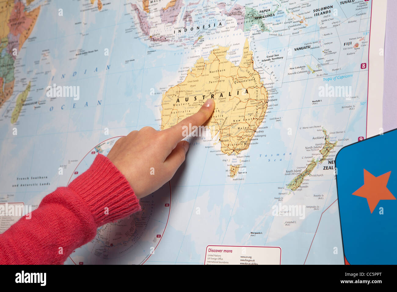 Young girl pointing to different countries on the world map-close-up Stock Photo