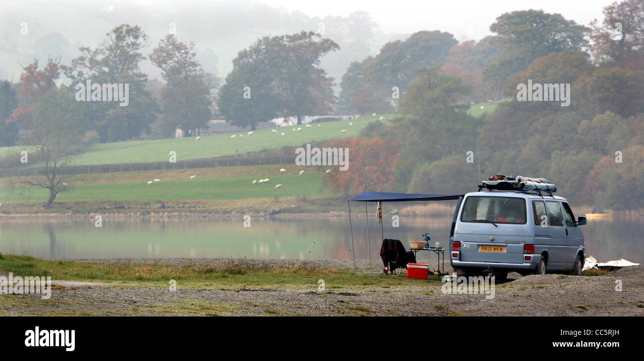 Holiday makers enjoy the peace and tranquility of Bala Lake, North Wales from their campervan. Stock Photo