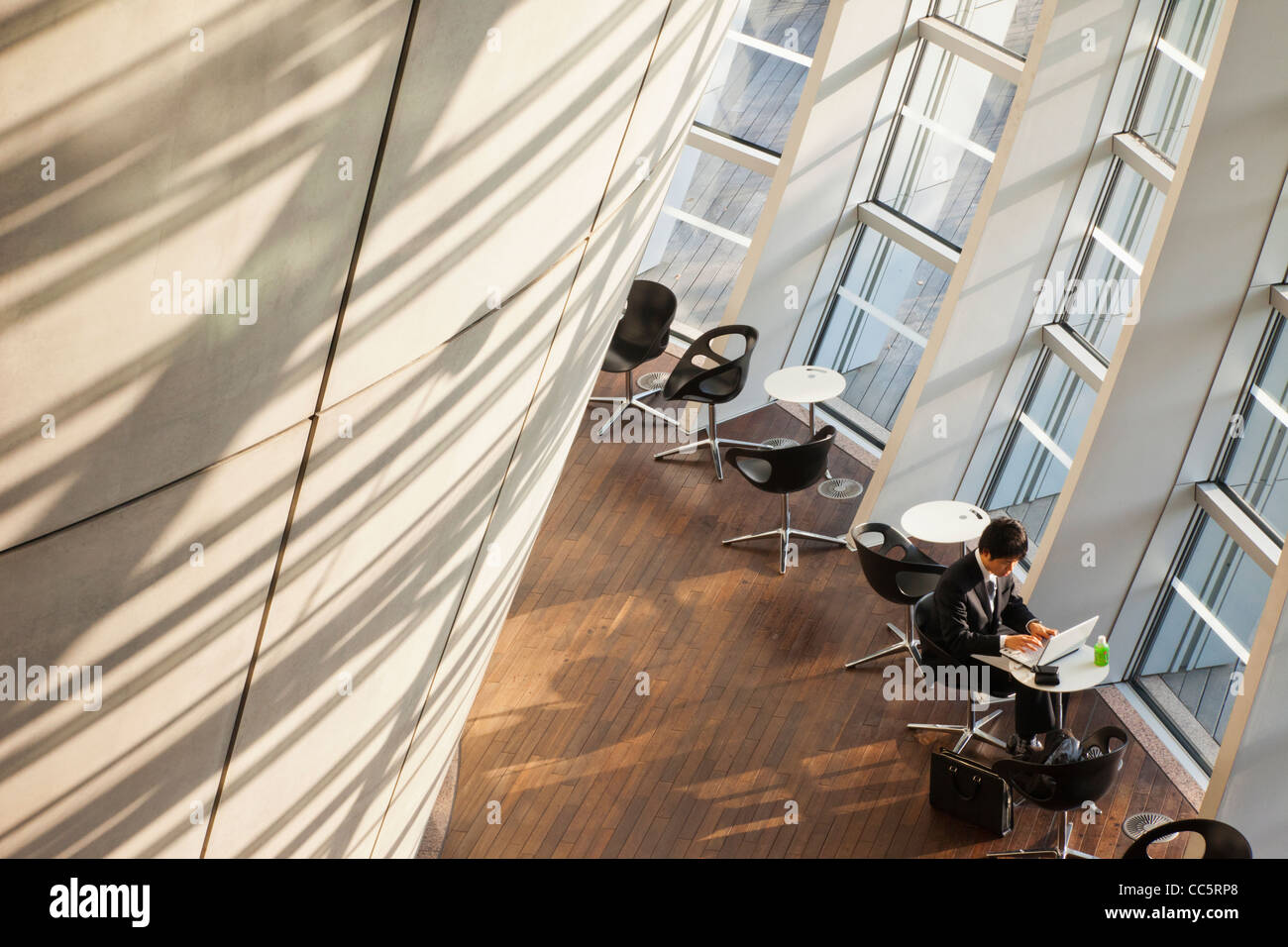 Japan, Tokyo, Roppongi, Tokyo National Art Center, Interior View with Man Using Computer Stock Photo