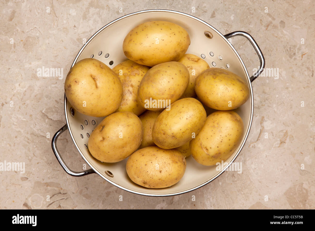 Potatoes in colander Stock Photo